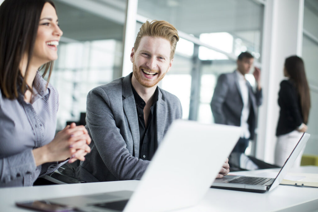 young professionals laughing in a meeting