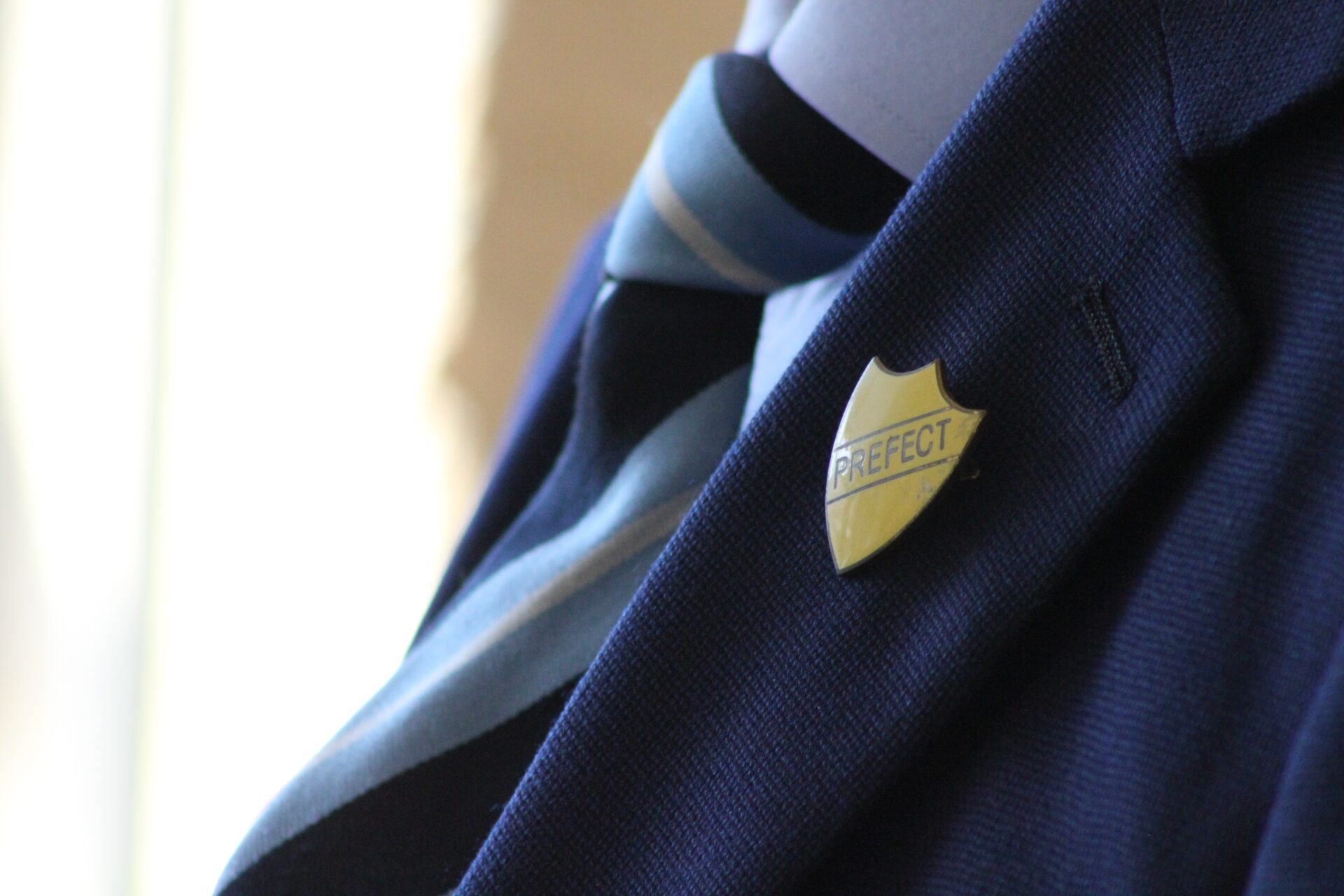 Vintage Prefect badge on old school uniform